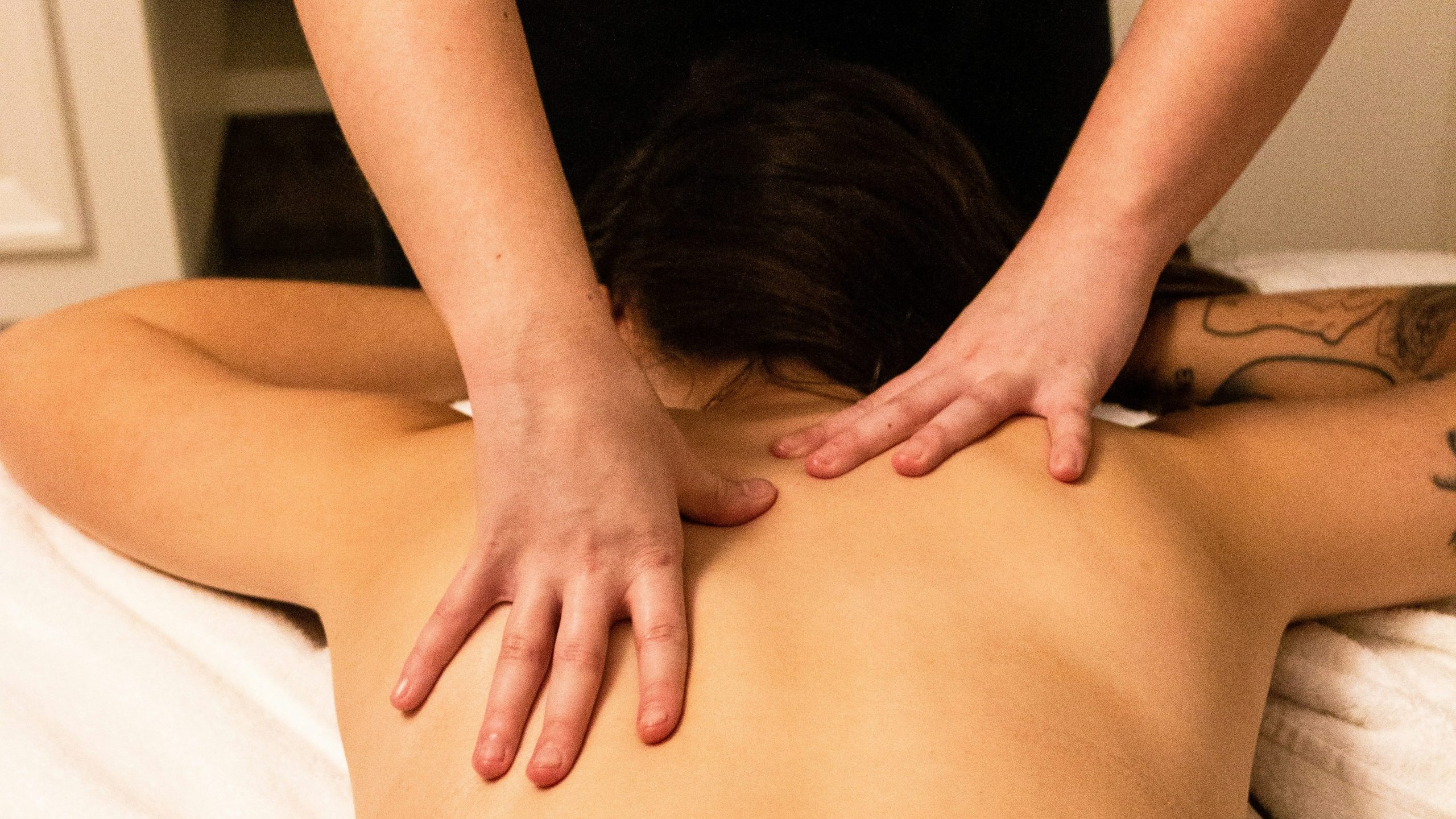 a woman getting a back massage at a spa